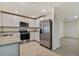 Modern kitchen with white cabinets and stainless steel appliances at 5552 Logan Cave Ave, Wimauma, FL 33598