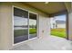 Covered patio with sliding glass doors offering a view of the lake at 5552 Logan Cave Ave, Wimauma, FL 33598