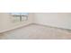 Well-lit bedroom with neutral carpeting at 5552 Logan Cave Ave, Wimauma, FL 33598