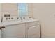 Laundry room with Whirlpool washer and dryer at 5552 Logan Cave Ave, Wimauma, FL 33598