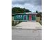 Teal house with coral door and small yard at 2569 Langdon S Ave, St Petersburg, FL 33712