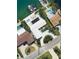 Stunning aerial view of a waterfront home with pool, boat dock and circular driveway at 440 64Th Ave, St Pete Beach, FL 33706