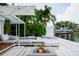 Beautiful backyard featuring a pool, patio, fire pit, and waterfront views, perfect for outdoor living at 440 64Th Ave, St Pete Beach, FL 33706