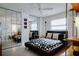 Stylish bedroom with mirrored closet doors and a patterned bedspread with colorful pillows at 440 64Th Ave, St Pete Beach, FL 33706