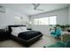 Bright bedroom features a large window, ceiling fan, stylish furniture, and vibrant plants for a lively atmosphere at 440 64Th Ave, St Pete Beach, FL 33706
