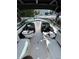 The interior of the boat has white leather seats with black accents and a sunroof at 440 64Th Ave, St Pete Beach, FL 33706