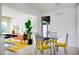 Modern dining area with a glass table and sleek chairs, adjacent to living room at 440 64Th Ave, St Pete Beach, FL 33706