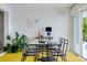 Dining room with a glass table, modern chairs, and access to the outdoor pool area at 440 64Th Ave, St Pete Beach, FL 33706