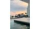 Picturesque view of boat on lift at sunset by the water, showcasing waterfront living at 440 64Th Ave, St Pete Beach, FL 33706