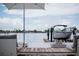 Beautiful dock with a boat lift, lounging area, and waterfront views perfect for relaxation and entertaining at 440 64Th Ave, St Pete Beach, FL 33706