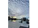 Beautiful water view with a private dock and boat lift under an interesting and picturesque clouded sky at 440 64Th Ave, St Pete Beach, FL 33706