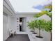 Bright entrance with white walls, an open door and some green plants in white pots, creating a fresh and inviting welcome at 440 64Th Ave, St Pete Beach, FL 33706