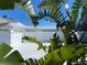 Contemporary home with white exterior, manicured landscaping, and a modern design, surrounded by palm trees at 440 64Th Ave, St Pete Beach, FL 33706