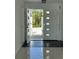 Bright entryway with an open white door and views of the front garden at 440 64Th Ave, St Pete Beach, FL 33706