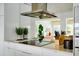 Gourmet kitchen features modern appliances, a range hood, and ample counter space at 440 64Th Ave, St Pete Beach, FL 33706