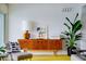 Mid-century modern living room with stylish furniture, a large plant, and a bright yellow rug at 440 64Th Ave, St Pete Beach, FL 33706