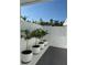 Cozy outdoor patio with white planters and a white privacy fence, ideal for relaxation and gardening at 440 64Th Ave, St Pete Beach, FL 33706