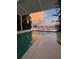 Beautiful pool area with serene water views, featuring a sculpture and seating to enjoy a sunset at 440 64Th Ave, St Pete Beach, FL 33706