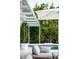 Inviting pool area surrounded by lush greenery, featuring a shaded lounge area perfect for relaxing at 440 64Th Ave, St Pete Beach, FL 33706
