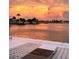 Gorgeous water view of the bay with boats docked from an outdoor patio at sunset at 440 64Th Ave, St Pete Beach, FL 33706