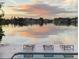Calm water view of the bay with boats docked from an outdoor patio at sunset at 440 64Th Ave, St Pete Beach, FL 33706
