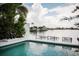 Waterfront view showcasing a boat lift and surrounding waterway, and clear skies at 440 64Th Ave, St Pete Beach, FL 33706