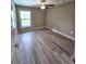 Spacious bedroom with wood-look floors and a ceiling fan at 1495 Robwood Ter, North Port, FL 34288