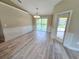 Spacious dining area with wood-look flooring and pool view at 1495 Robwood Ter, North Port, FL 34288