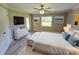 Main bedroom with large bed, dresser, and access to backyard at 1495 Robwood Ter, North Port, FL 34288