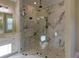 Large walk-in shower with marble tile and glass enclosure at 241 5Th N Ave, Safety Harbor, FL 34695