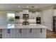 Modern kitchen with white cabinets, large island, and stainless steel appliances at 241 5Th N Ave, Safety Harbor, FL 34695