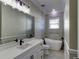 Modern bathroom with white vanity, freestanding tub, and tile shower at 241 5Th N Ave, Safety Harbor, FL 34695