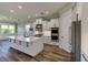 White kitchen features a large island, double ovens, and hardwood floors at 241 5Th N Ave, Safety Harbor, FL 34695