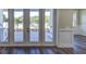 View of backyard through french doors, showcasing patio and lush landscaping at 241 5Th N Ave, Safety Harbor, FL 34695