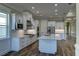 Modern kitchen boasts white cabinets, a large island, and stainless steel appliances at 241 5Th N Ave, Safety Harbor, FL 34695