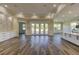 Open living room with hardwood floors, stone feature wall, and access to backyard at 241 5Th N Ave, Safety Harbor, FL 34695