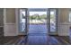 Spacious backyard with patio and tropical landscaping, accessible through french doors at 241 5Th N Ave, Safety Harbor, FL 34695