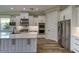 Spacious kitchen with white cabinets, large island, and stainless steel appliances at 241 5Th N Ave, Safety Harbor, FL 34695