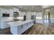 Modern kitchen with white cabinets, large island, and stainless steel appliances at 241 5Th N Ave, Safety Harbor, FL 34695