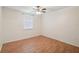 Spacious bedroom with laminate wood flooring and ceiling fan at 4244 Tamargo Dr, New Port Richey, FL 34652