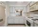 Kitchen with white cabinets and pass-through at 4244 Tamargo Dr, New Port Richey, FL 34652