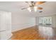 Living room with laminate floors, ceiling fan, and sliding glass doors at 4244 Tamargo Dr, New Port Richey, FL 34652