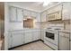 Bright kitchen features white cabinets and appliances at 4244 Tamargo Dr, New Port Richey, FL 34652