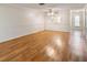 Living room with wood floors and access to kitchen at 4244 Tamargo Dr, New Port Richey, FL 34652