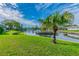 Landscaped backyard with a pond and lush vegetation at 4244 Tamargo Dr, New Port Richey, FL 34652