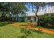Front view of charming condo with metal roof and walkway at 4244 Tamargo Dr, New Port Richey, FL 34652