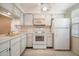 Efficient kitchen with white cabinets and appliances at 4244 Tamargo Dr, New Port Richey, FL 34652