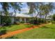 Charming light blue building with metal roof and manicured lawn at 4244 Tamargo Dr, New Port Richey, FL 34652