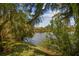 Peaceful view of a canal from a lush green backyard at 4244 Tamargo Dr, New Port Richey, FL 34652