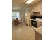Kitchen with light cabinets, tile floor, and dinette set at 2367 N Bentley Dr, Palm Harbor, FL 34684